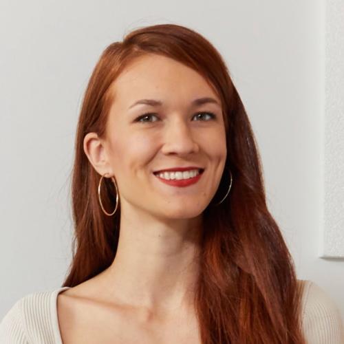Laura Burget smiling, indoors.