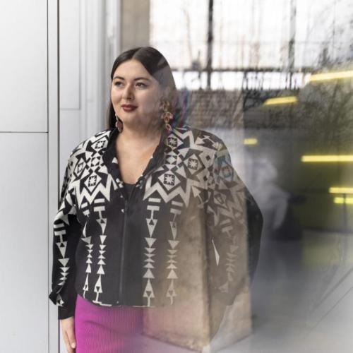 Lesley Hampton standing outside a U of T Mississauga building, smiling