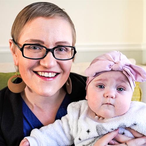Margaret Loniewska smiles as she cuddles her baby daughter.
