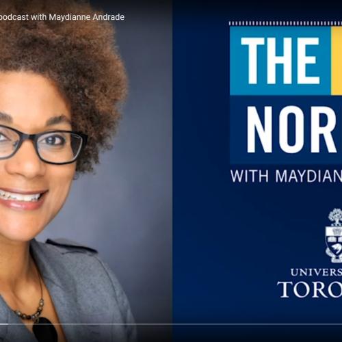 Maydianne Andrade smiles next to a screen showing the name of her podcast: The New Normal.