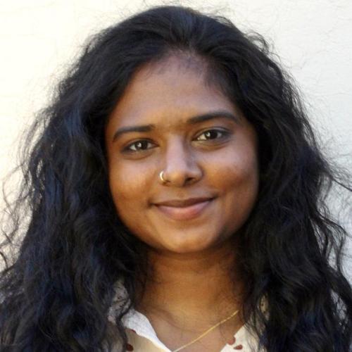 Portrait of Mullai Sampath smiling.