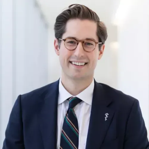 A portrait of Dr. Nowak wearing a suit and smiling