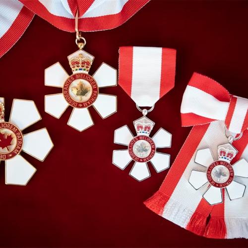 Order of Canada medals on a red surface