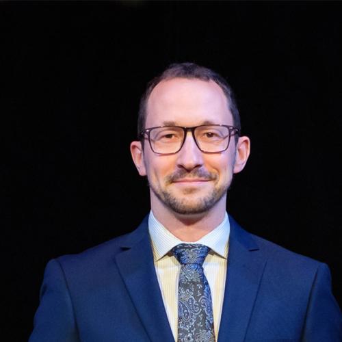 Portrait of Ryan Henderson smiling slightly.