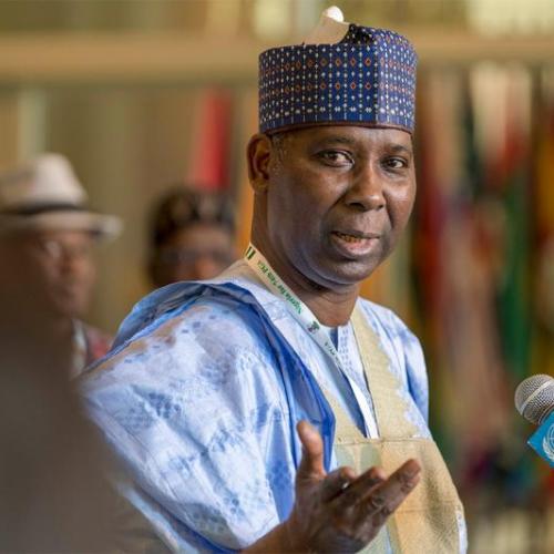 Tijjani Muhammad-Bande, wearing traditional Nigerian clothing, speaks before a United Nations microphone.