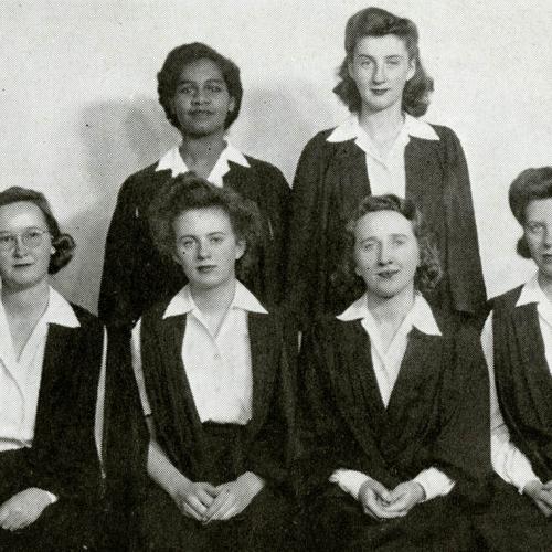 Gloria Carpenter stands in the back row of a formal photo of six women from her 1945 yearbook.