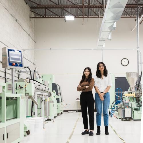 Two young women standing in a lab