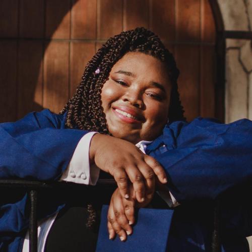 Carisse Samuel in her graduation robes, smiling 