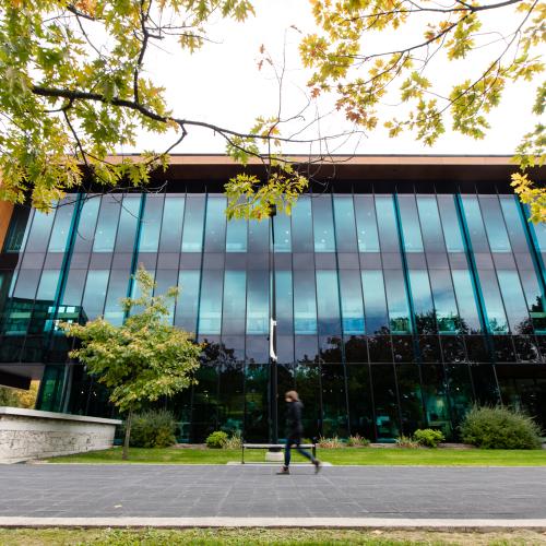 The Hazel McCallion Academic Learning is shaped like a shoebox with wooden sides and an entire wall of glass windows.
