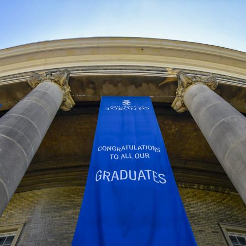 Banners hang between the pillars at Convocation Hall. They read: Congratulations to all our graduates