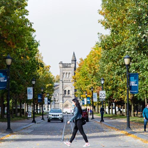 Students walk along King's College Road with University College in the background.