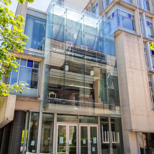 The exterior of the Bahen Centre, a brick building with one glass wall, and home of the department of computer science.