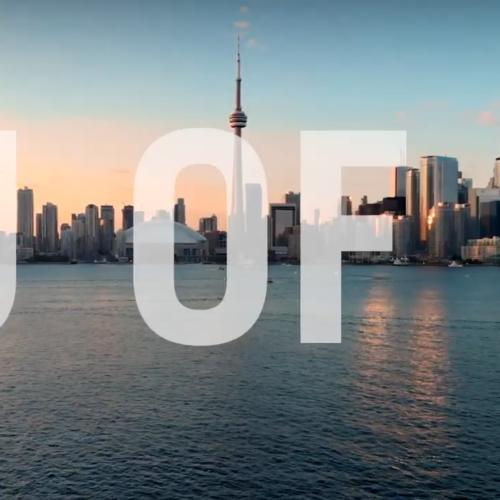 The letters U of T appear superimposed across Toronto's lakefront skyline, with the sun setting.