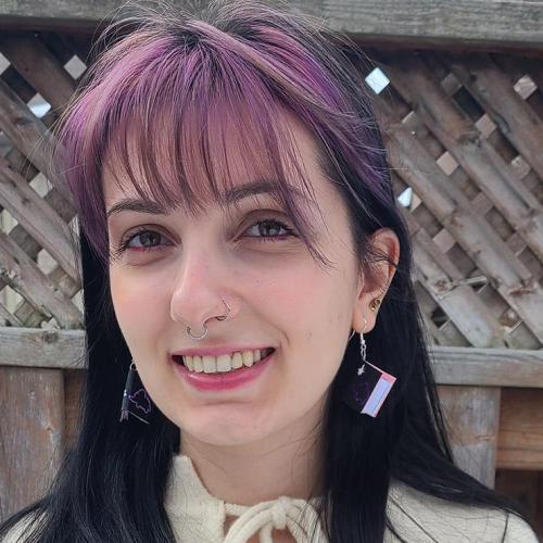 Vanessa Parise smiles, standing on a patio outdoors.
