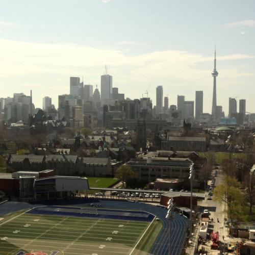 The view from a window in the OISE building looks over Varsity Stadium and downtown Toronto.