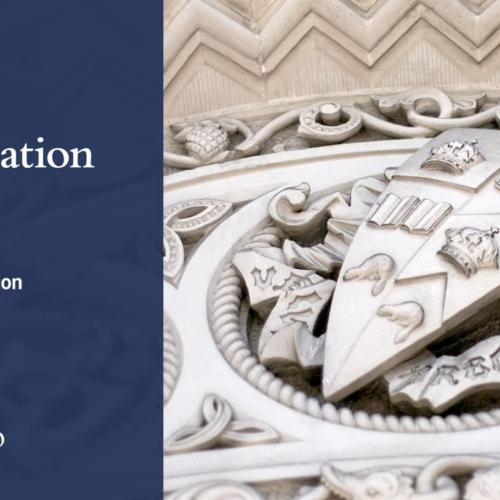 A screenshot from U of T's Spring 2020 Virtual Convocation shows a stone carving of the University crest.
