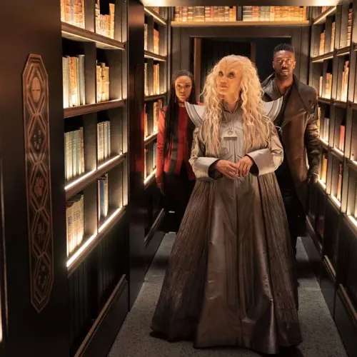 Three Star Trek characters standing in library stacks