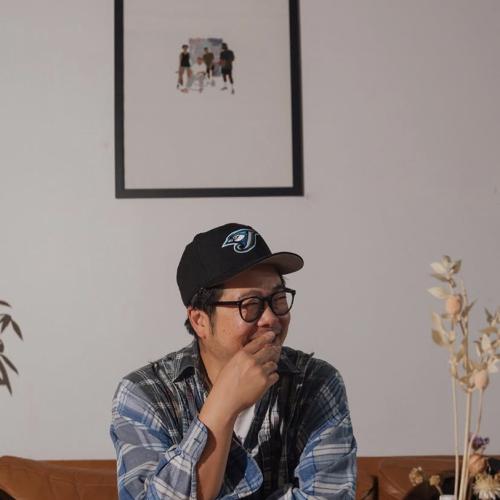 Alex Wong wearing a baseball cap