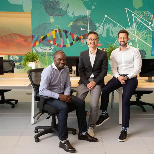 The three co-founders of BenchSci, Elvis Wianda, Tom Leung and Liran Belenzon, sitting in an office and smiling