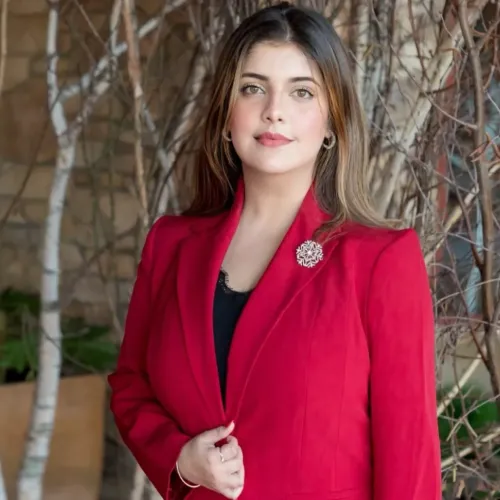 A portrait of a woman wearing a red blazer