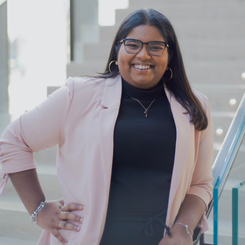 Delicia Raveenthrarajan stands with her hands on her hips