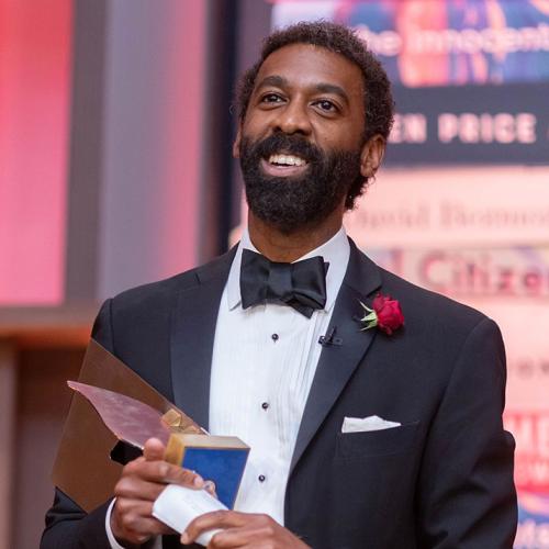 Photo of Kai James holding the 2019 Giller Prize