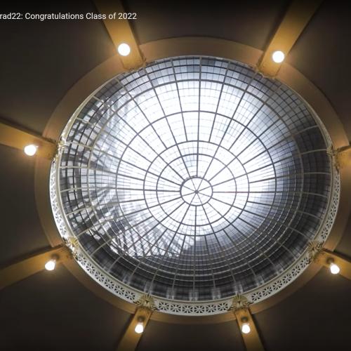 Lights shine like stars around the bright oculus window in the ceiling of Convocation Hall.