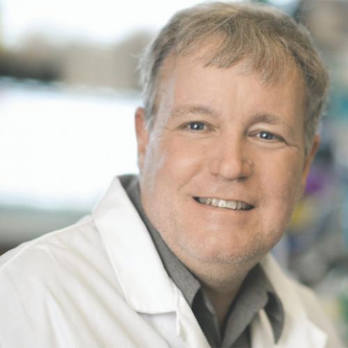 Portrait of Jeff Wrana smiling and wearing a lab coat.