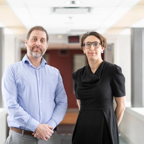 Robert Kozak and Samira Mubareka stand in a sunny hallway.