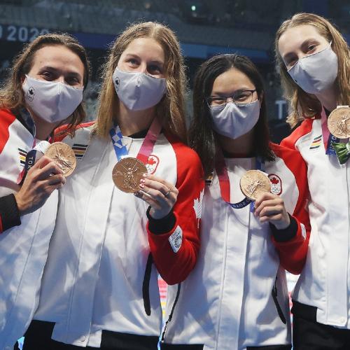 Kylie Masse, Sydney Pickrem, Maggie Mac Neil and Penny Oleksiak hold up their bronze medals for relay swimming.