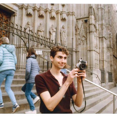 Phil Schwarz takes a photo while standing on the steps of the elaborate Sagrada Familia cathedral in Barcelona.