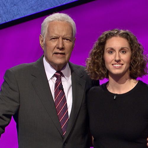 Brooke Mackenzie smiles while posing for a picture with Alex Trebek.