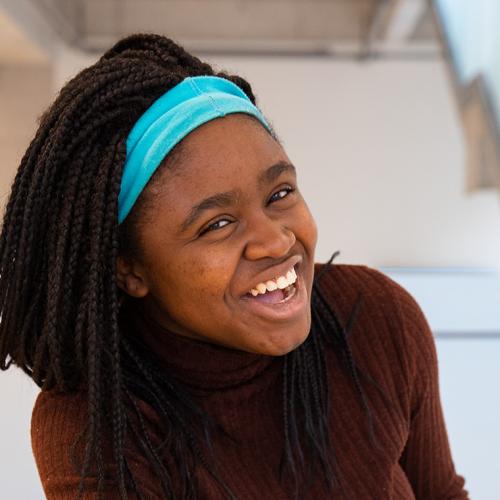 Portrait of Deb Raji laughing.