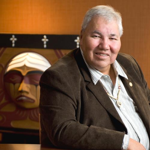 Senator Murray Sinclair is seated in front of the TRC Bentwood Box, carved by Coast Salish artist Luke Marston (photo courtesy of University of Manitoba) 