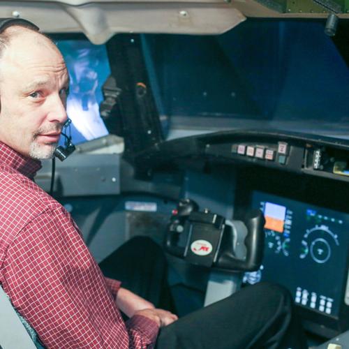 U of T Engineering's Peter Grant practices responding to an aerodynamic stall in a flight simulator at the University of Toronto Institute for Aerospace Studies (photo by Marit Mitchell) 