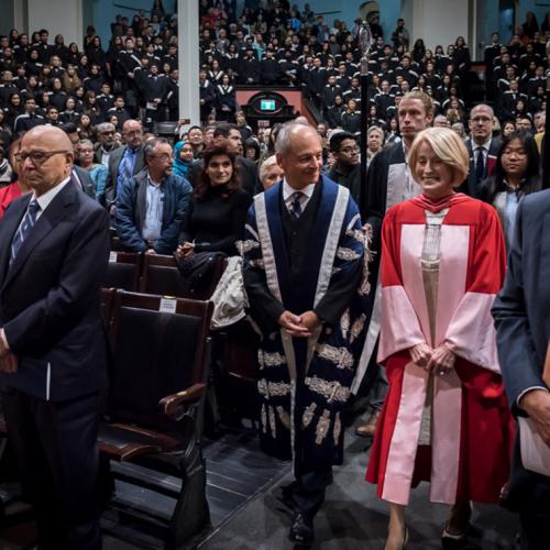 Rose Patten enters Convocation Hall with U of T President Gertler in advance of the robing ceremony. Her husband Tom Di Giacomo is second from the left (photo by Lisa Sakulensky) 