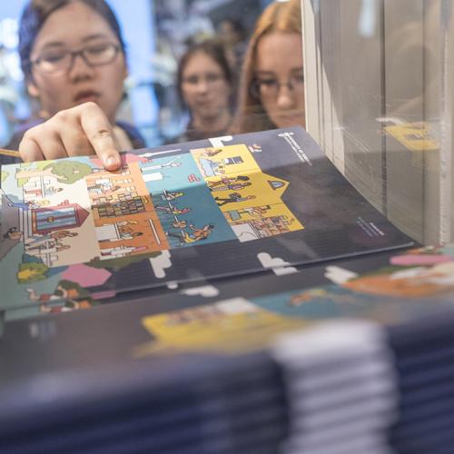 A visitor picks up promotional material at the U of T exhibitor booth at last fall's Ontario Universities' Fair. More Ontario high school students, domestic and international, ranked U of T first in applications (photo by Geoffrey Vendeville) 