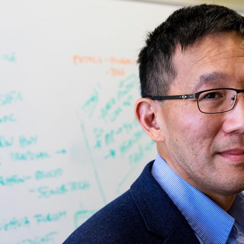 New Dean of U of T Engineering Christopher Yip stands in front of a whiteboard, looking thoughtful (photo by Chris Sorensen) 