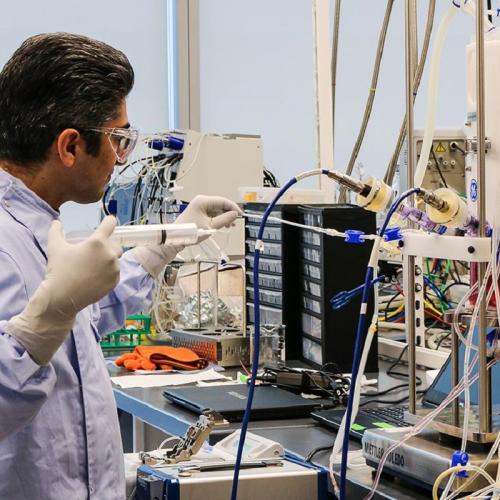 A researcher at the Centre for Advanced Therapeutic Cell Technologies pulls a sample of pluripotent stem cells from a bioreactor. The reactor, which uses disposable bags, can generate up to 25 billion cells at a time (photo by Jennifer Robinson) 