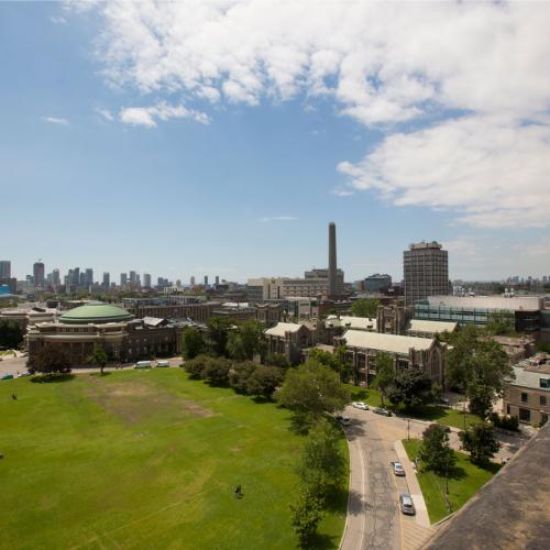 From the roof of University College, Front Campus looks lush, and is surrounded by U of T buildings and the Toronto skyline.