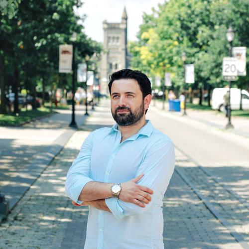 Khaled Almilaji stands on King's College Road with University College in the background.