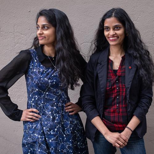 Identical twins Sandhya and Swapna Mylabathula stand side by side, smiling and laughing  (photo by Geoffrey Vendeville) 