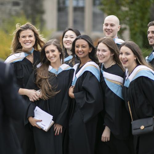 Group of graduates posing together on convocation day.