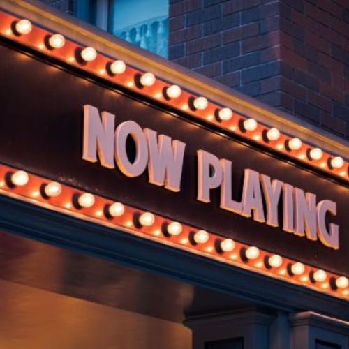 theatre signage that says "now playing"