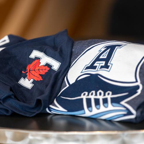 Varsity Blues shirt beside a Toronto Argonauts shirt