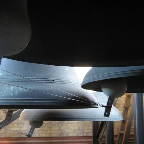 Sunlight glinting on large bells