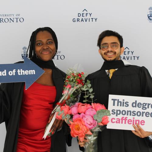 U of T Grads holding props at a photo booth