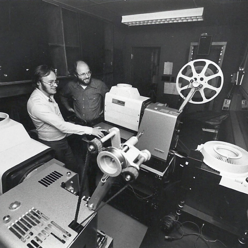 Innis Town Hall projection booth being operated by David Clanfield and Joe Medjuck. 