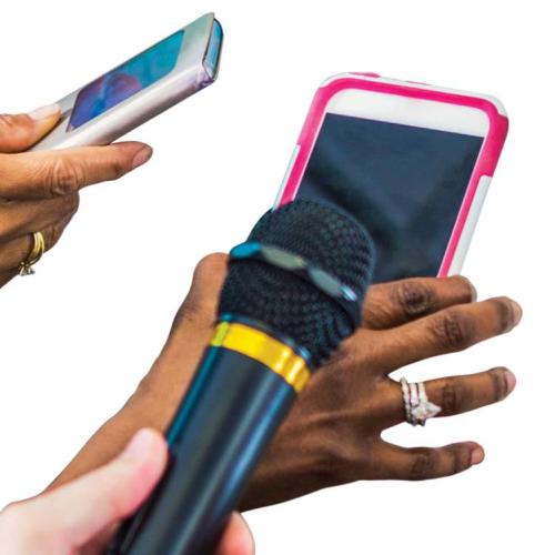 Several people holding smart phones and microphones as if recording an interview.