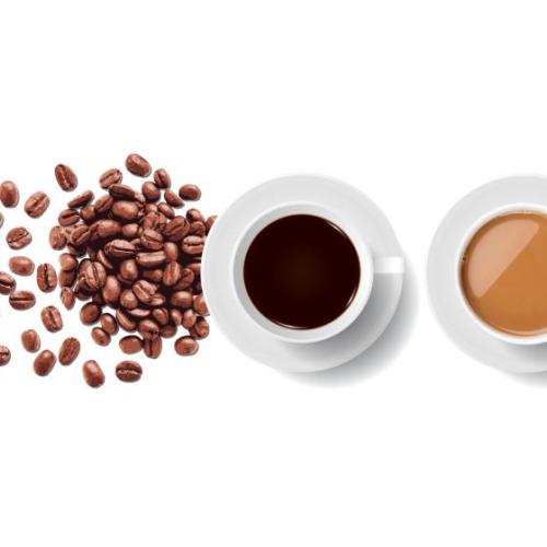 Coffee beans and two coffee cups.
